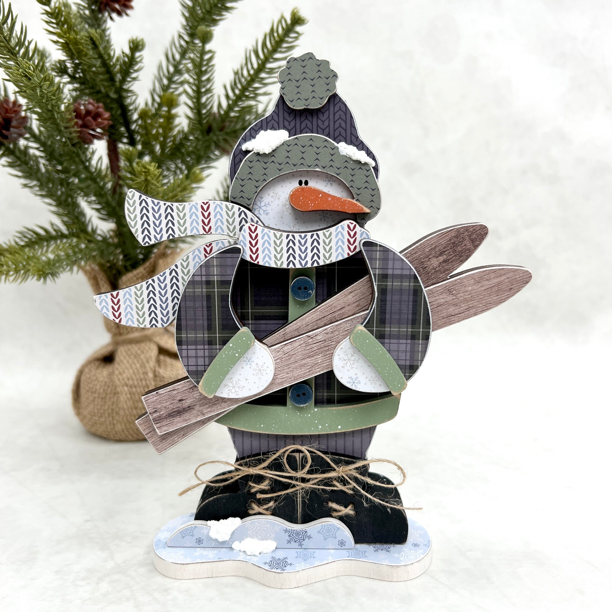 Standing snowman holding a pair of skiis wood decor for tiered trays, shelves, and table tops