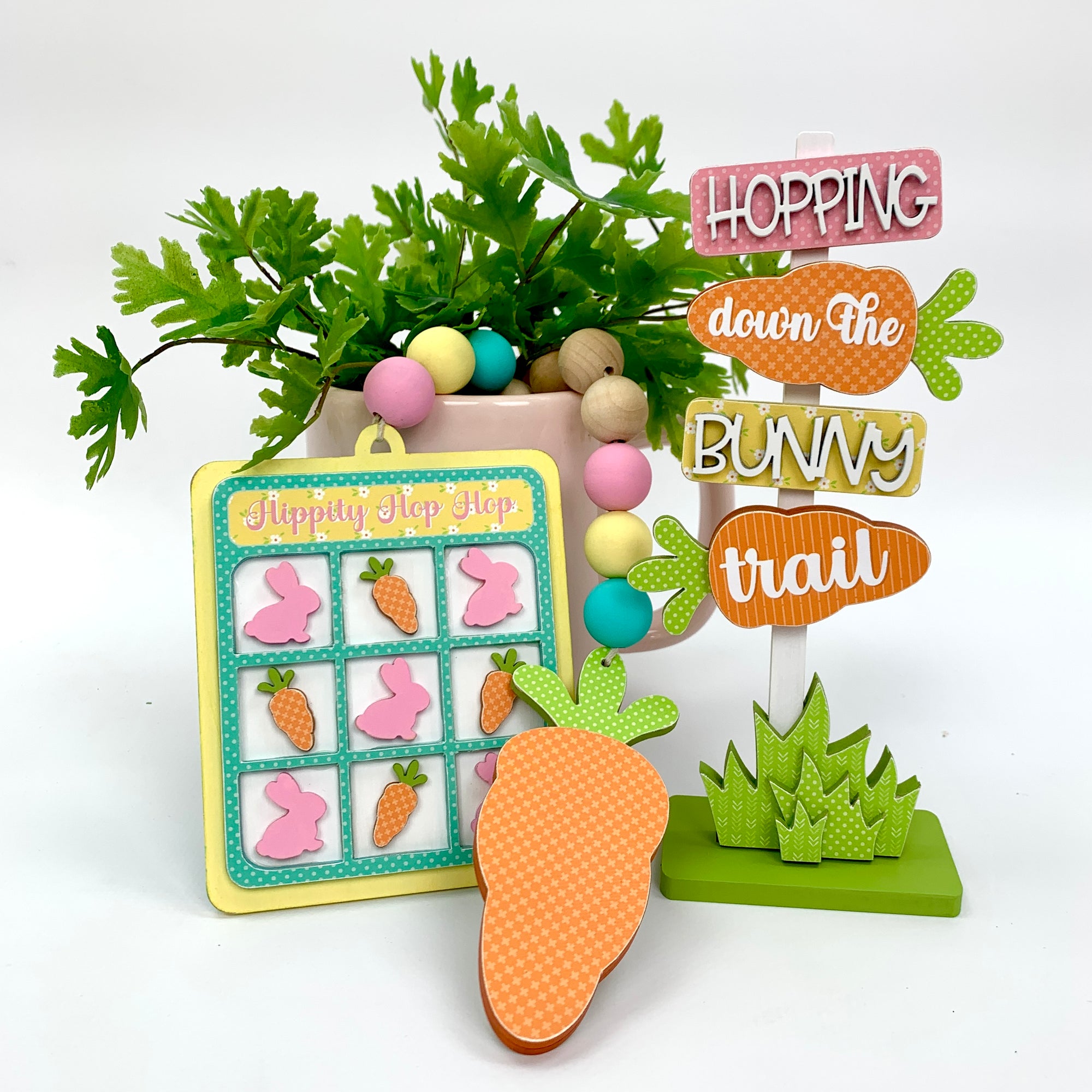 Easter sign that says hopping down the bunny trail and a wood beaded tic tac toe and carrot garland.