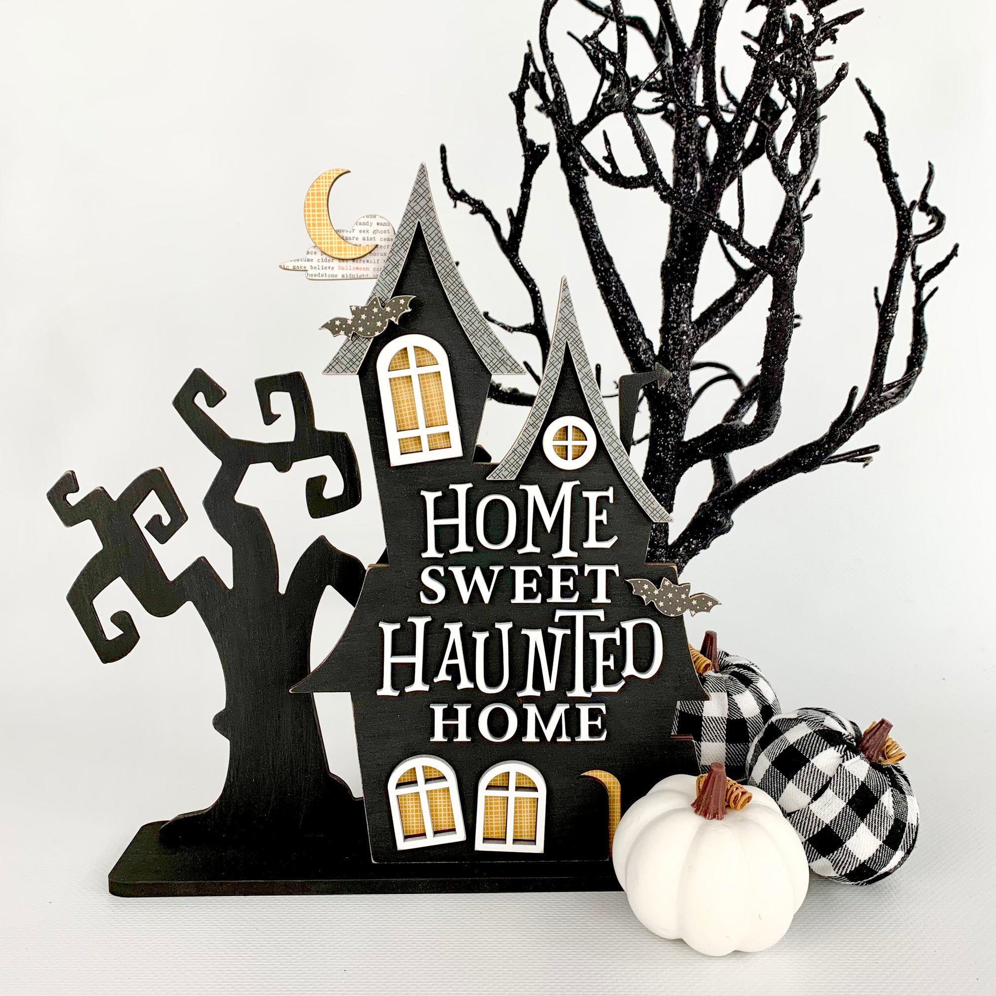 Halloween black and white wood haunted house with a Home sweet haunted home phrase, windows, bats, and a spooky tree.  Haunted house for Halloween home decor.  Halloween wood craft kit.