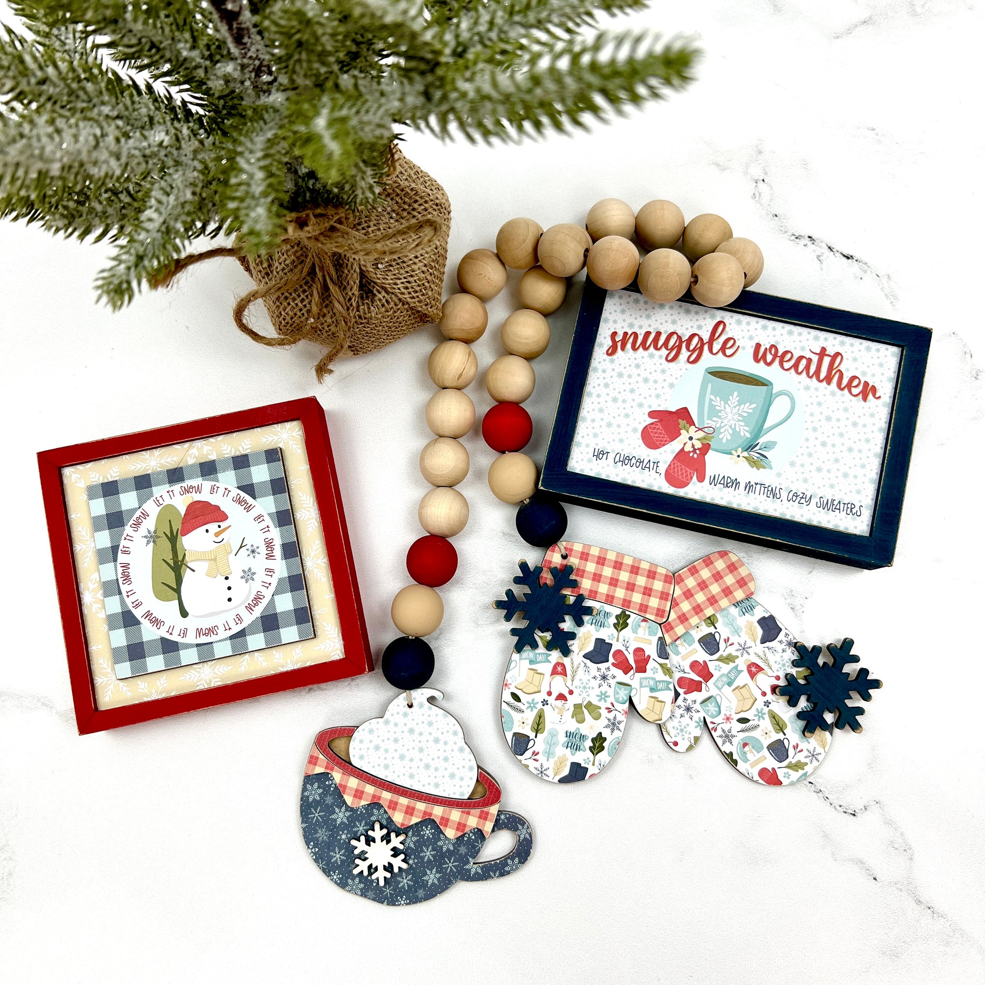 Winter signs with wood beaded garland with mittens and a cocoa cup for styling tiered trays, table tops, and shelves