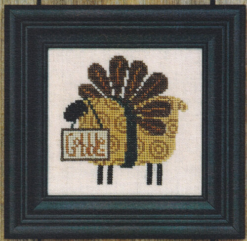 Cross-stitched turkey sheep with a sign that says 'Gobble'