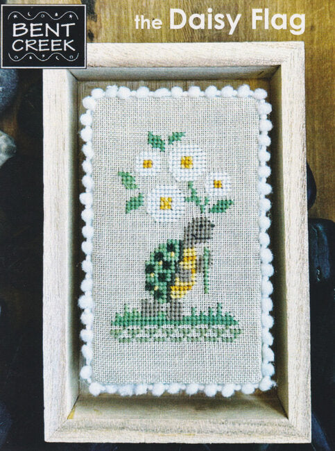 Cross-stitched daisy flag design featuring a Turtle