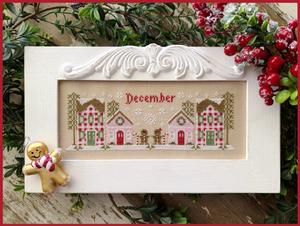 Decorative cross-stitch pattern with gingerbread houses and teddy bear, framed with 'December' text, surrounded by festive elements.
