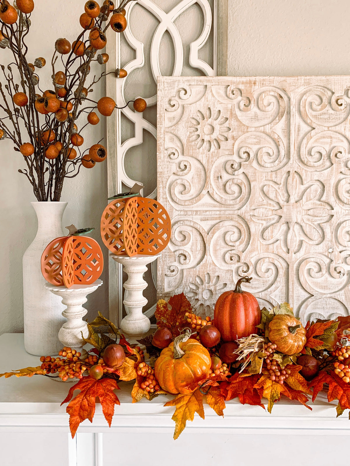 3D wood pumpkins craft kit, 3D pumpkins for fall decorations for a shelf or mantle. Dimensional pumkins shown on candlesticks on a fireplace.