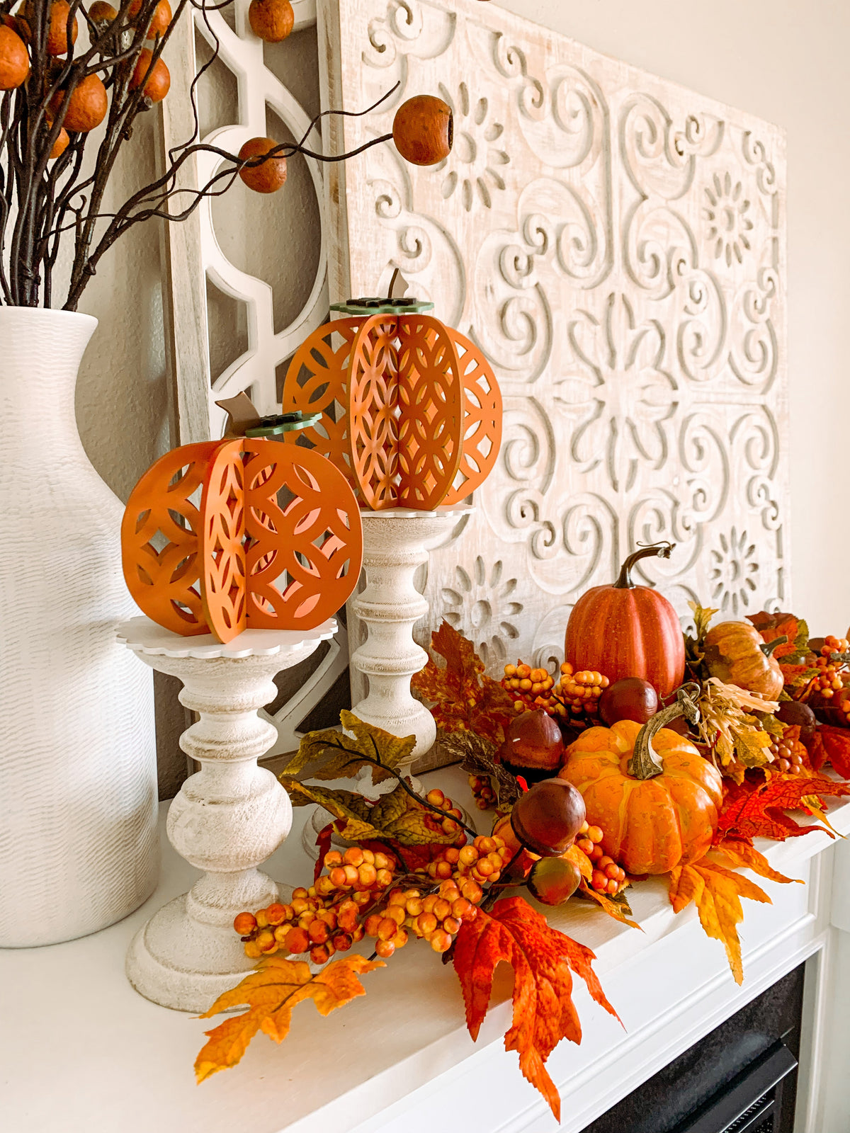 3D wood pumpkins craft kit, 3D pumpkins for fall decorations for a shelf or mantle. Dimensional pumkins shown on candlesticks on a fireplace.  Lattice looking dimensional pumpkins.