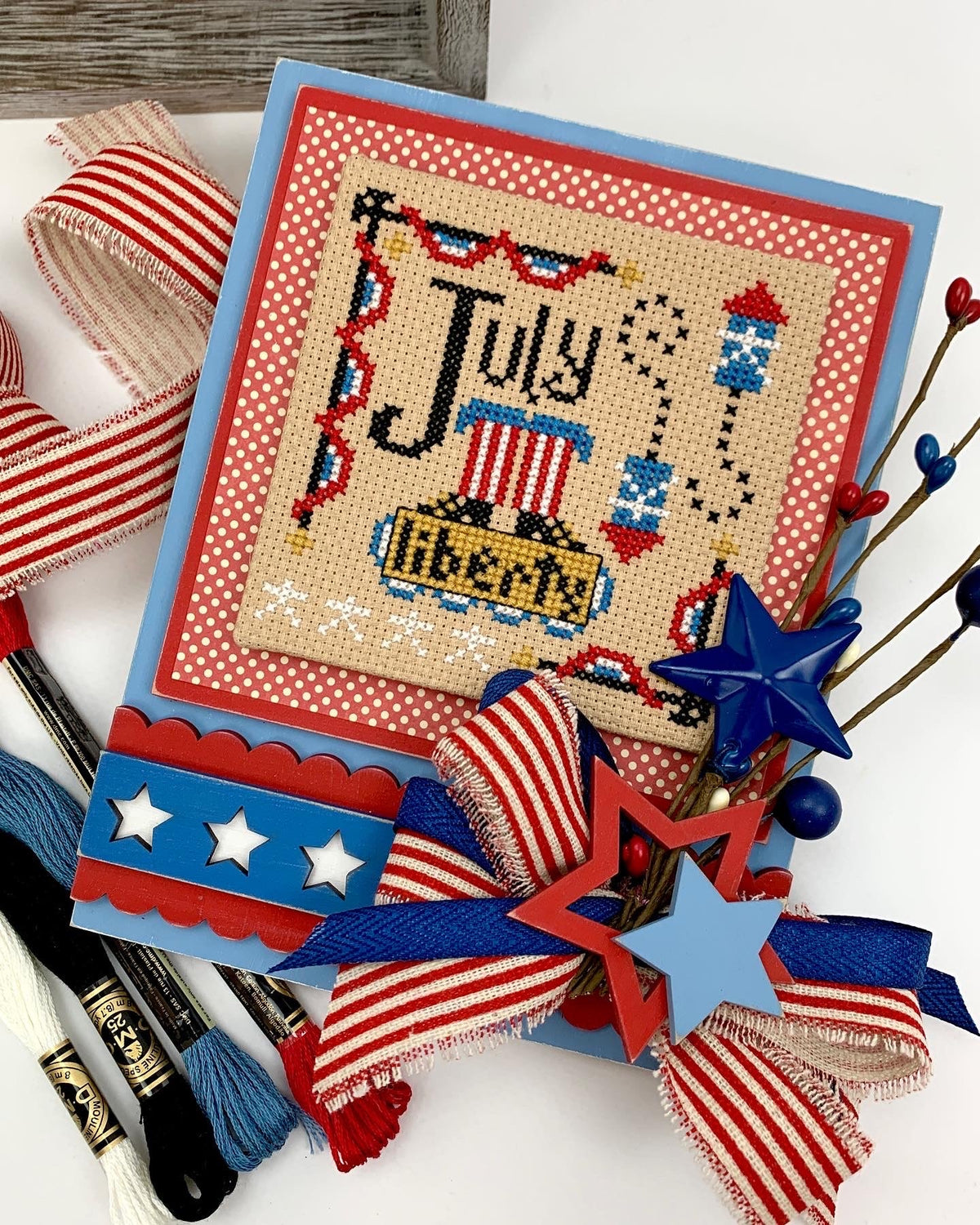 A year of celebrations Hands on Design July Cross stitch on wood backing with borders and stars. 