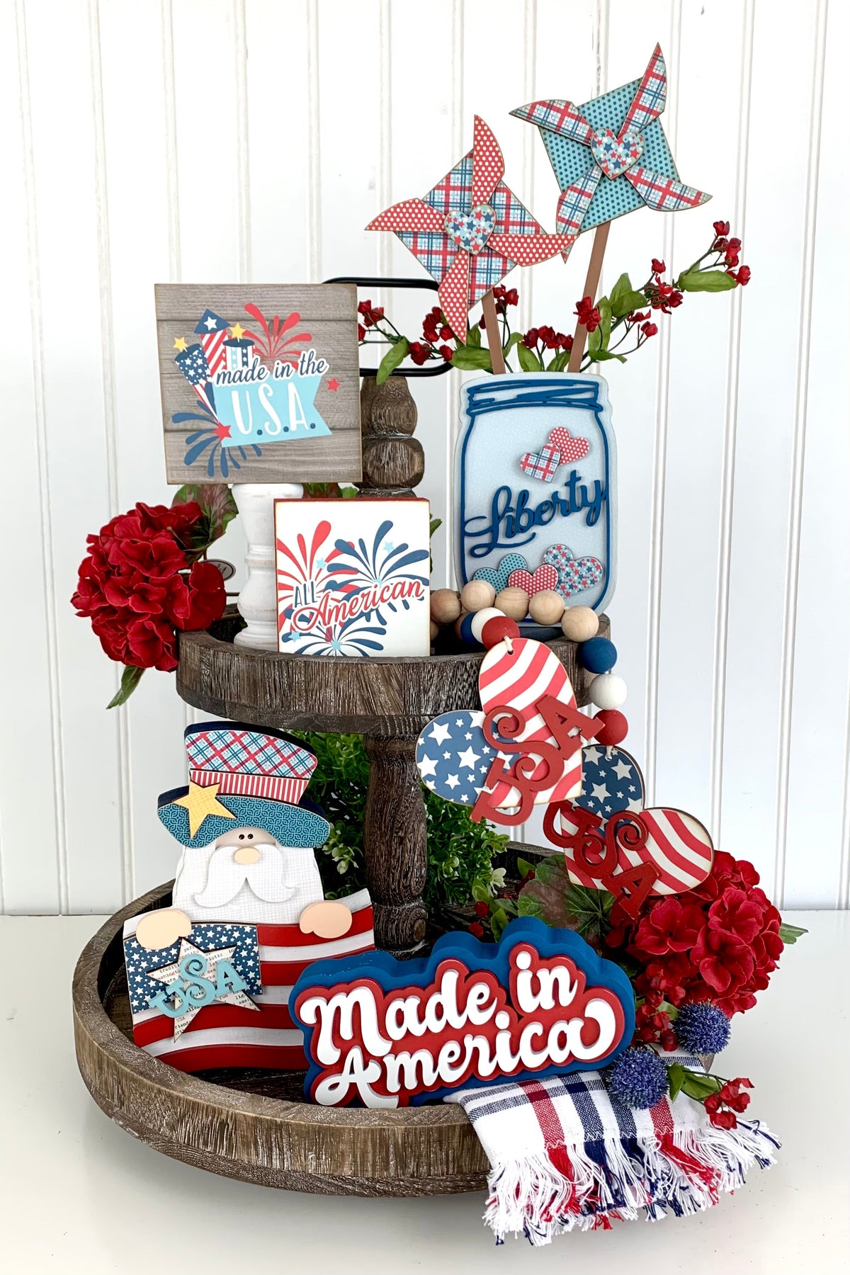 Patriotic or 4th of July tiered tray with a mason jar and other patriotic red, white, and blue wood decor pieces