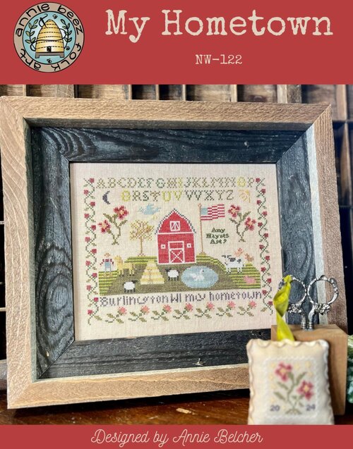 Schoolgirl Sampler Cross-stitched piece with a barn and farm design and 'My Hometown' text