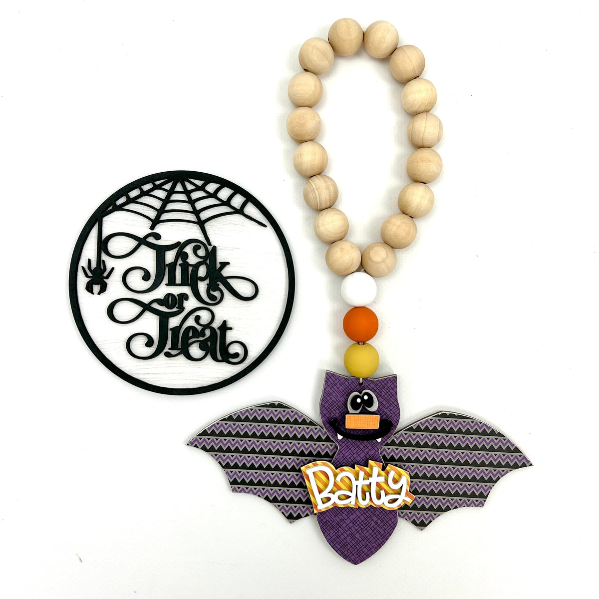 Wood trick or treat sign and wood beaded bat garland for Halloween decorations and Halloween themed tiered trays
