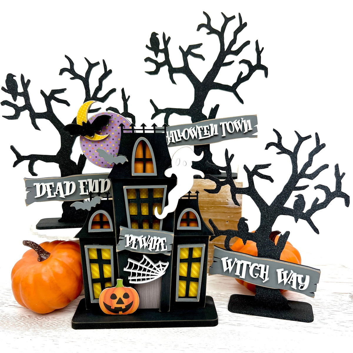 Black spooky trees and haunted house wood decorations for halloween