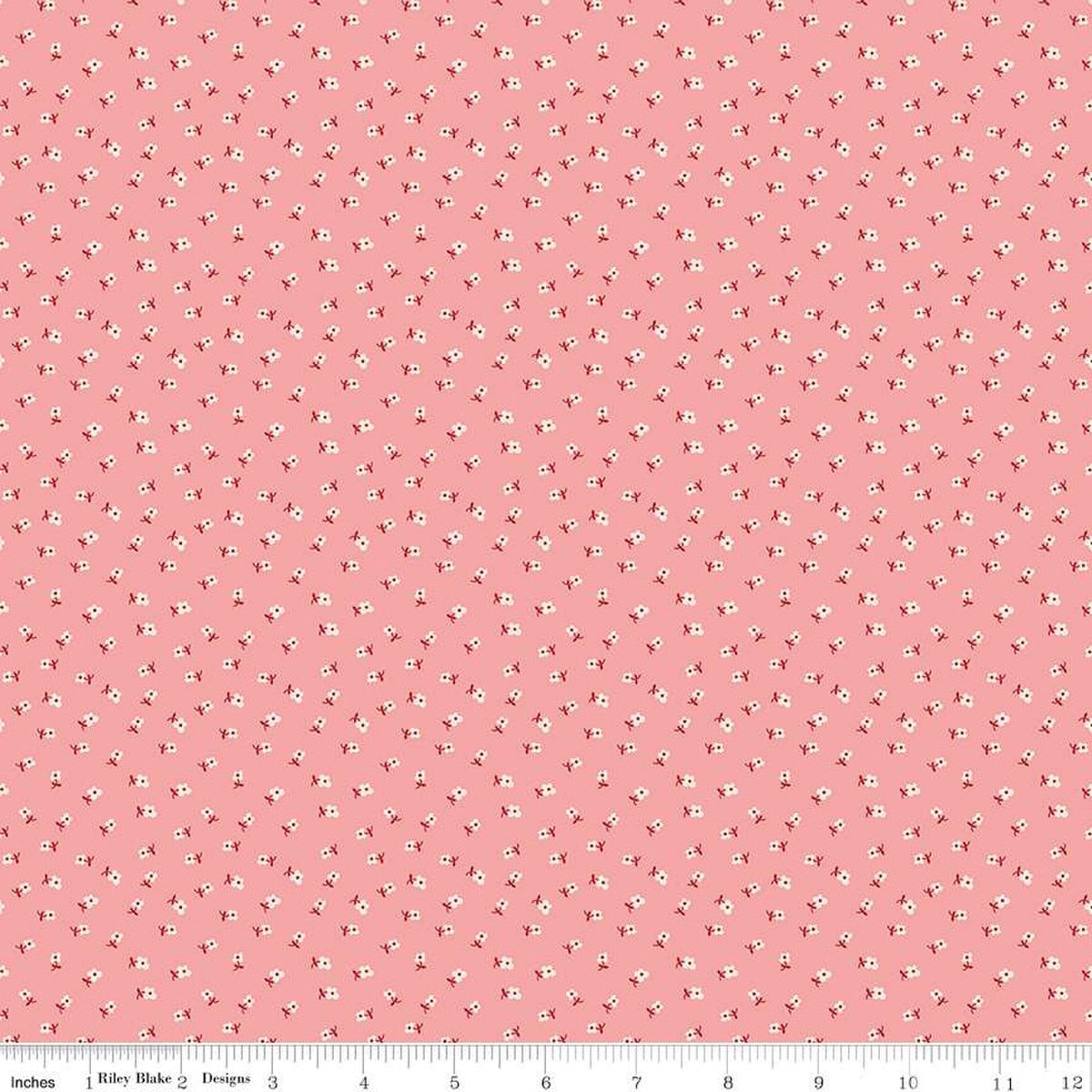 Pink fabric with small white floral pattern.