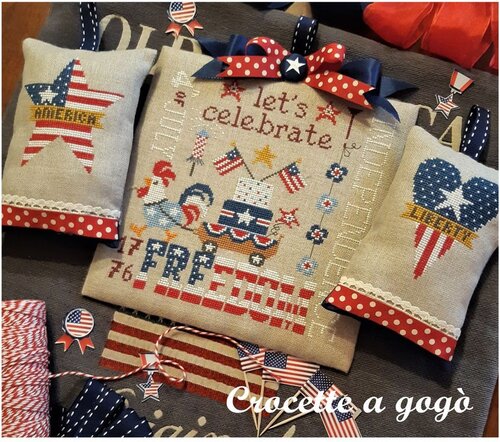Decorative pillows with three American-themed designs of an America star Liberty heart and rooster pulling a wagon of Americana and the word Freedom.