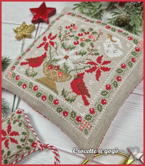 Cross-stitched Christmas floral design with red cardinals, poinsettias, and with a quilt design scissor fob.