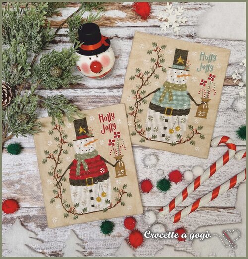 Two Holly Jolly Snowmen in red and winter blue surrounded by winter foliage. 