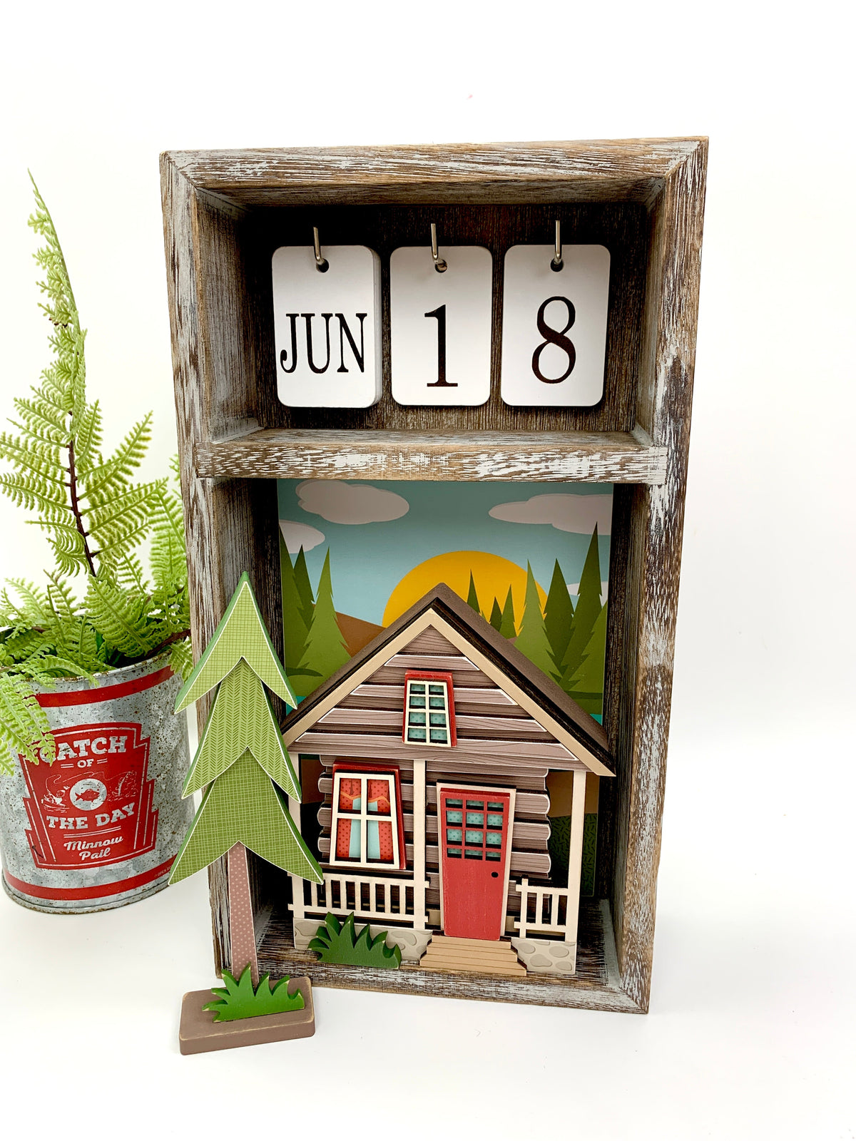 Outdoor cabin wood decor craft kit displayed in a changing calendar box