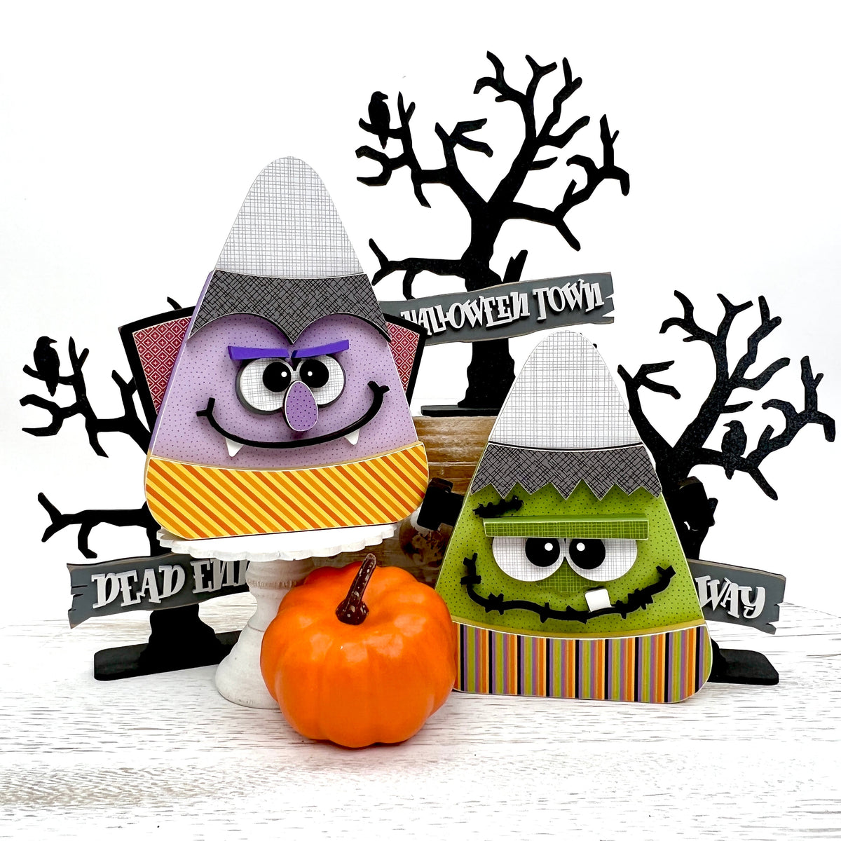 Frankenstein and Dracula wood decorations with spooky wood trees.