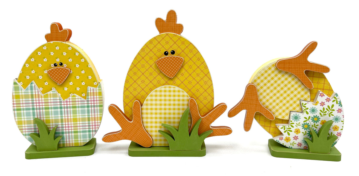 DIY wood craft kit with three yellow easter chicks sitting inside cracked eggs