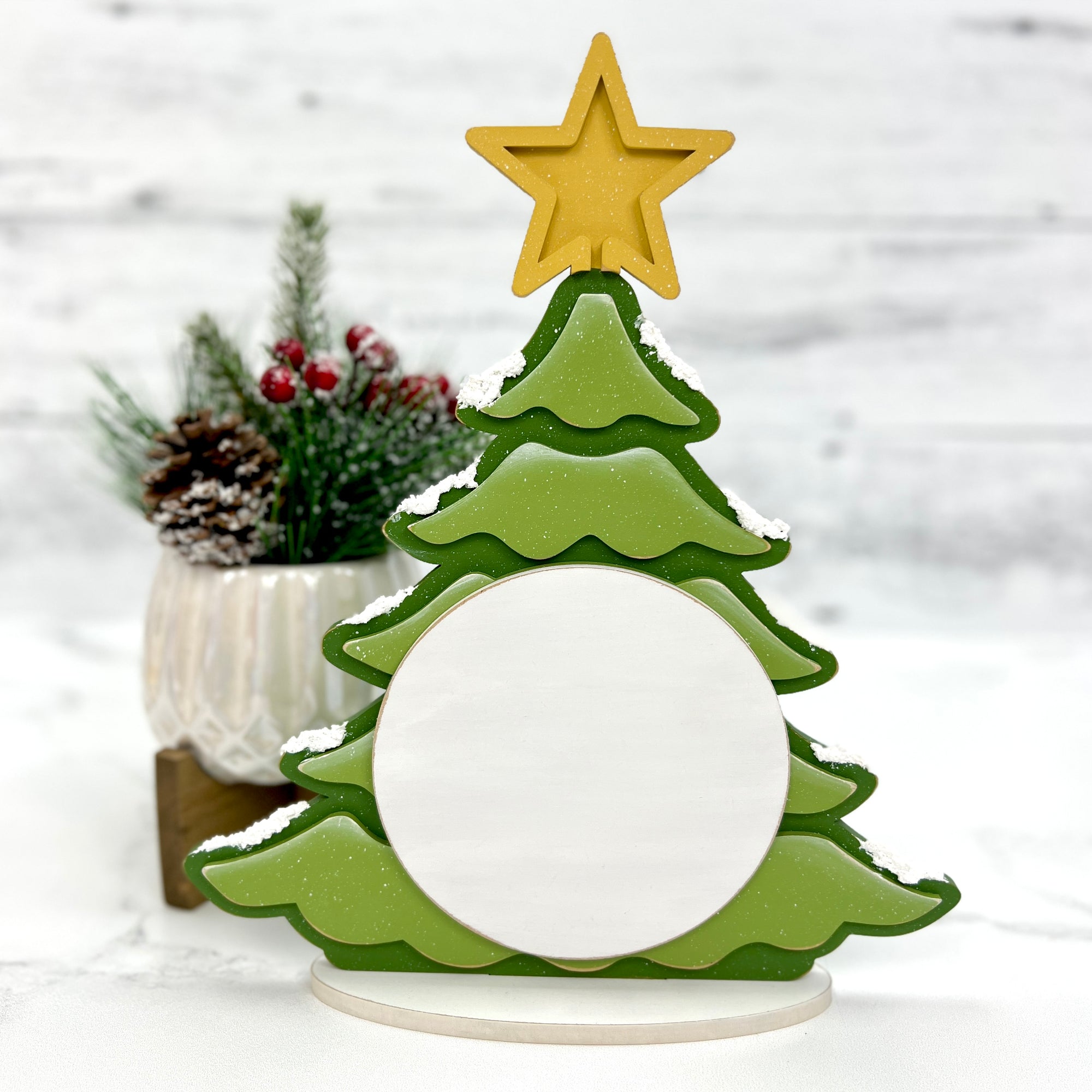 Green christmas tree with a gold star on top wood decor for displaying a finished cross stitch piece