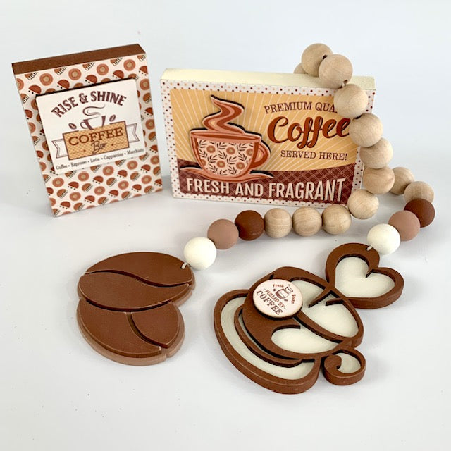 Coffee themed wood beaded garland with coffee beans and coffee cup. Two wood coffee signs for decorating trays, coffee bars, and coffee themed tiered trays. 