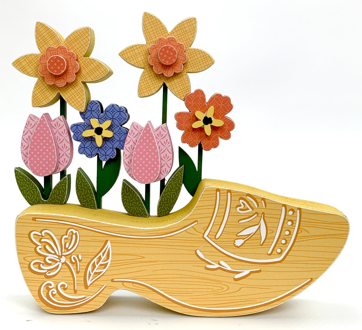 Yellow dutch clog wood decoration with spring flowers.
