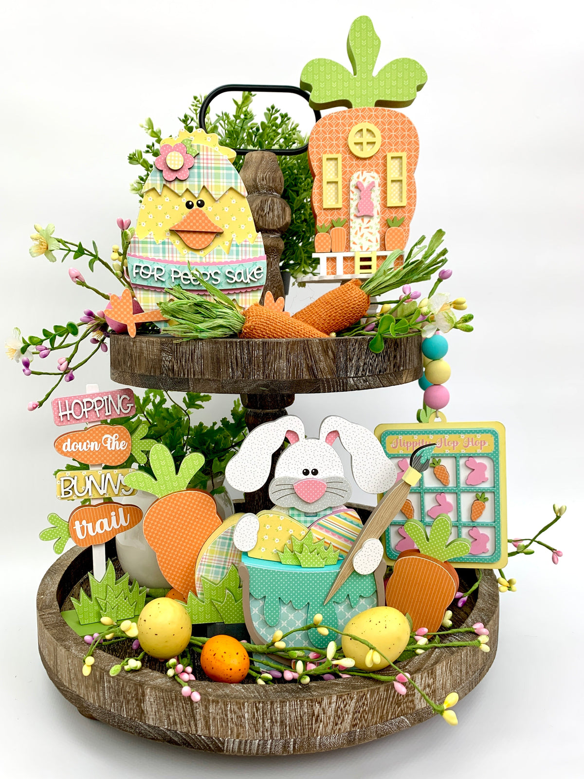 Easter tiered tray decorations; carrot house, bunny painting eggs, easter chick in cracked egg.