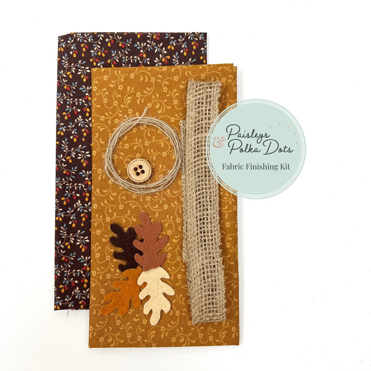 Fall Harvest fabric finishing kit with laser cut felt leaves wooden button jute ribbon floral fabric in cider and calico floral on dark chocolate brown with floral vines of gold red and blue