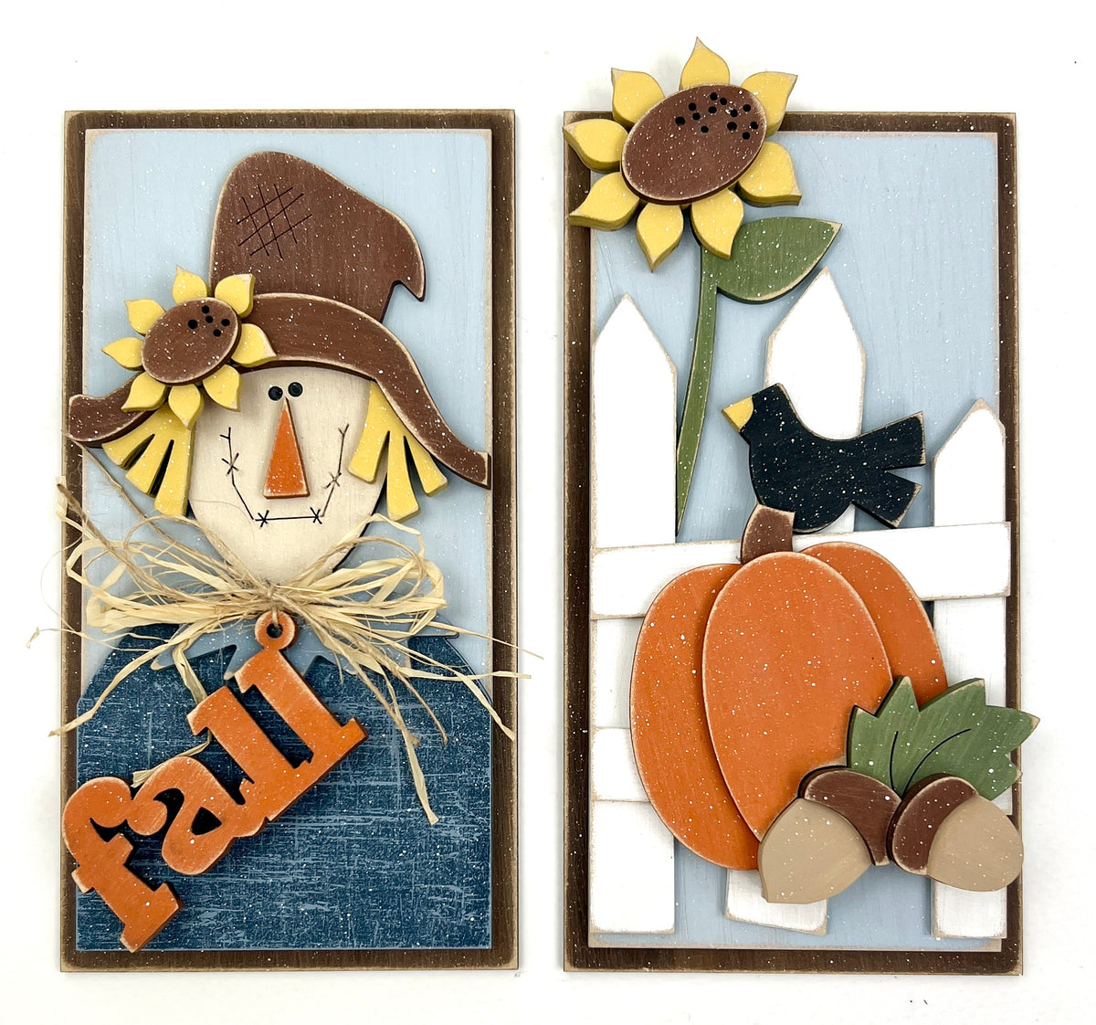 Fall cabinet door fronts with a scarecrow holding a “fall” sign and a pumpkin scene with sunflower, crow, and acorns on a rustic wood background.