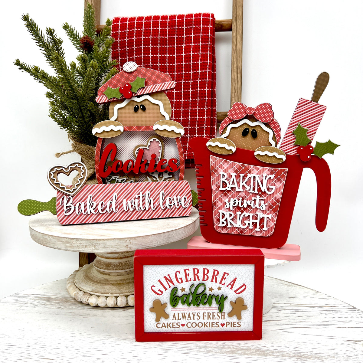 Gingerbread themed Christmas wood decorations with a gingerbread cookie jar, measuring cup with a gingerbread girl and rolling pin, and a gingerbread bakery sign