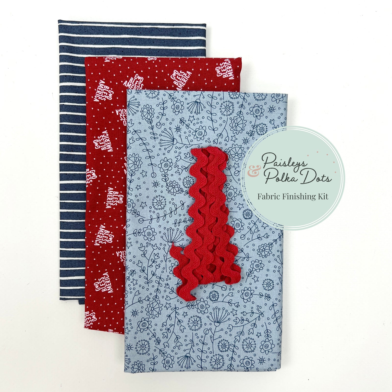 God Bless America Fabric finishing kit with three pieces of fabric navy and white stripes whimsical flowers red white and blue with red ric rac trim.