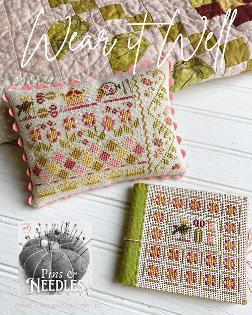 Cross-stitched pincushion pillow and needle minder book in a spring motif