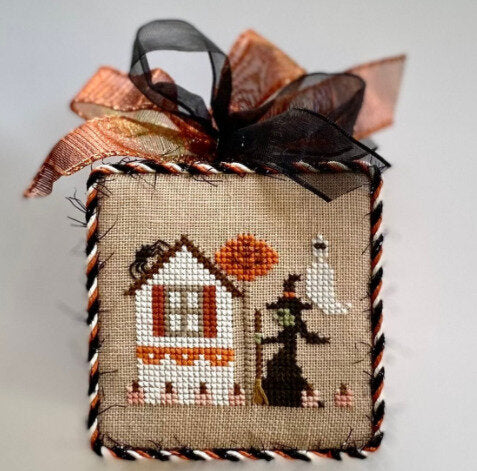 Halloween witch with broom, ghost and spider with a house