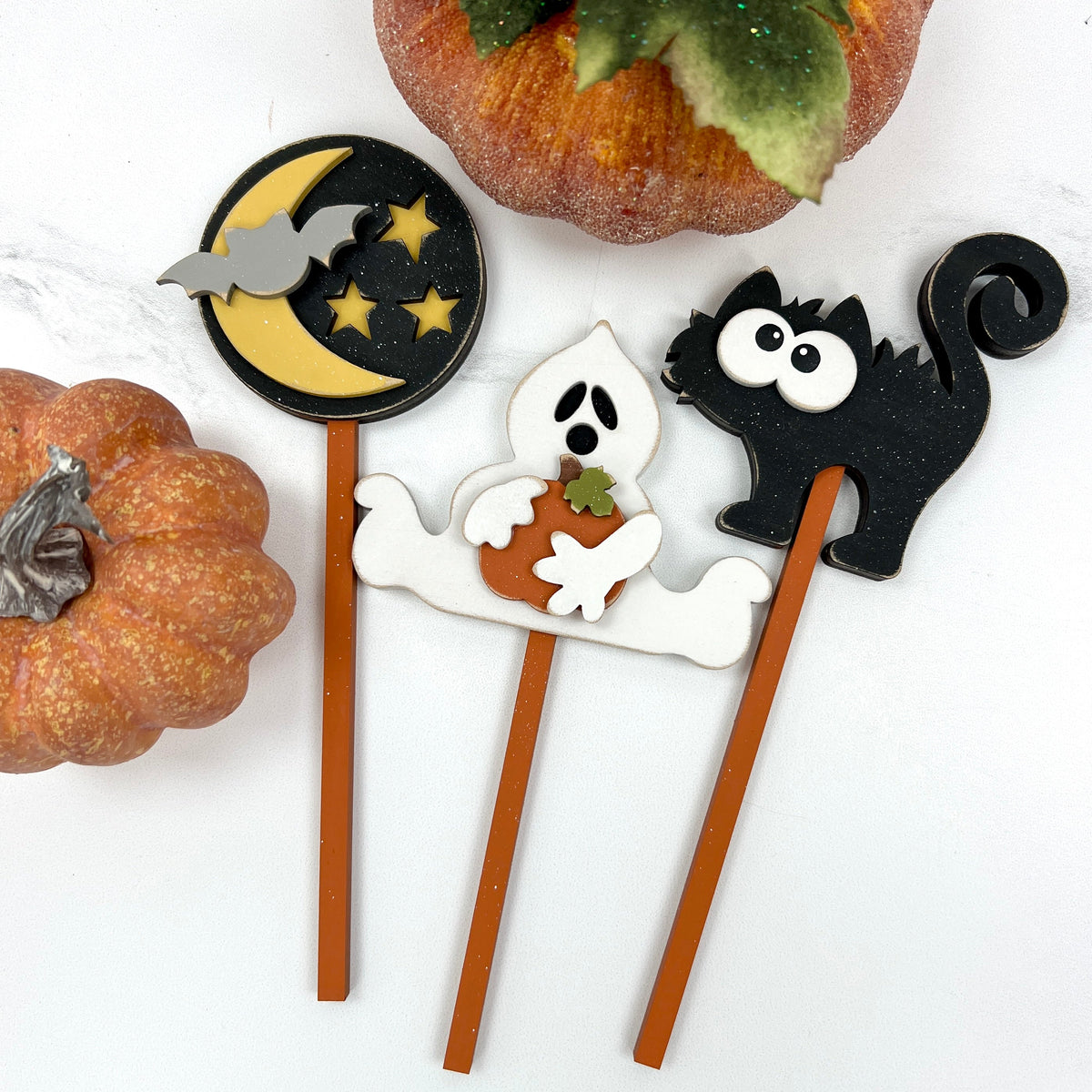 Halloween Wood mug decoration with a ghost. black cat, and moon with stars placed into the mug. 