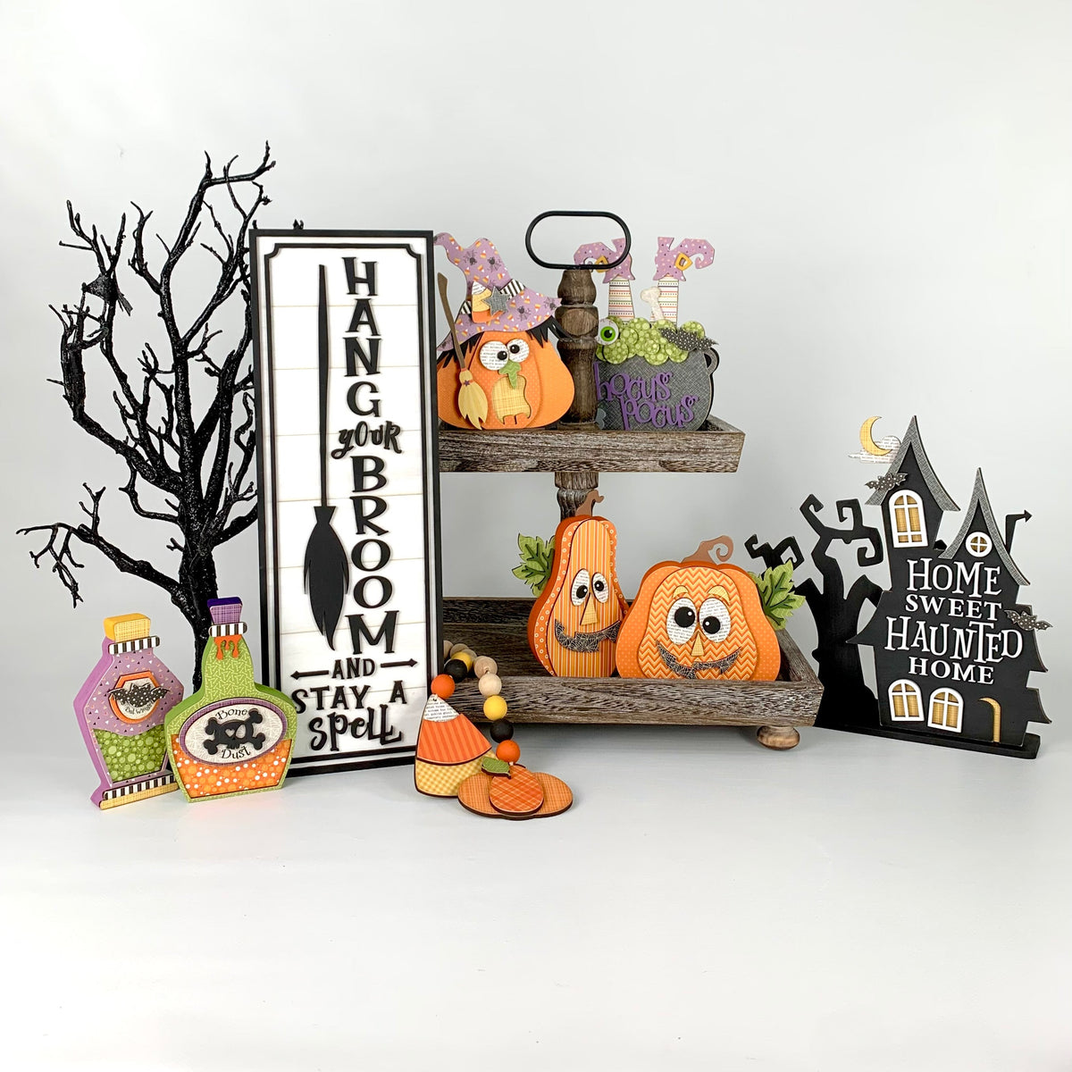 Black and white wood halloween dimensional shiplap sign with a witch pumpkin and hocus pocus witch cauldron with witches feet sticking out. Wood craft kits for making halloween decorations.
