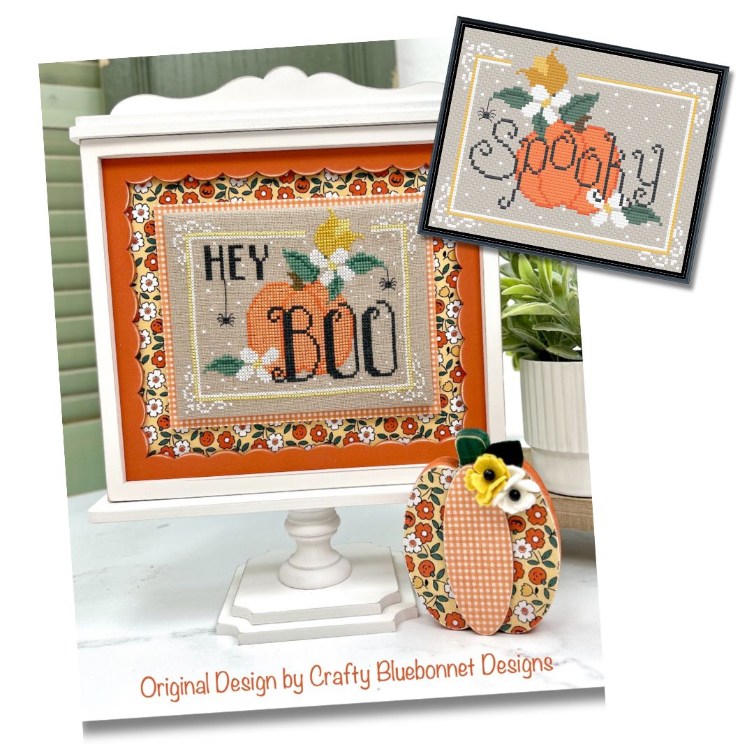 Decorative cross-stitch patterns with pumpkins and text, featuring 'Hey Boo' and 'Spooky' with yellow and white flowers and dangling spiders