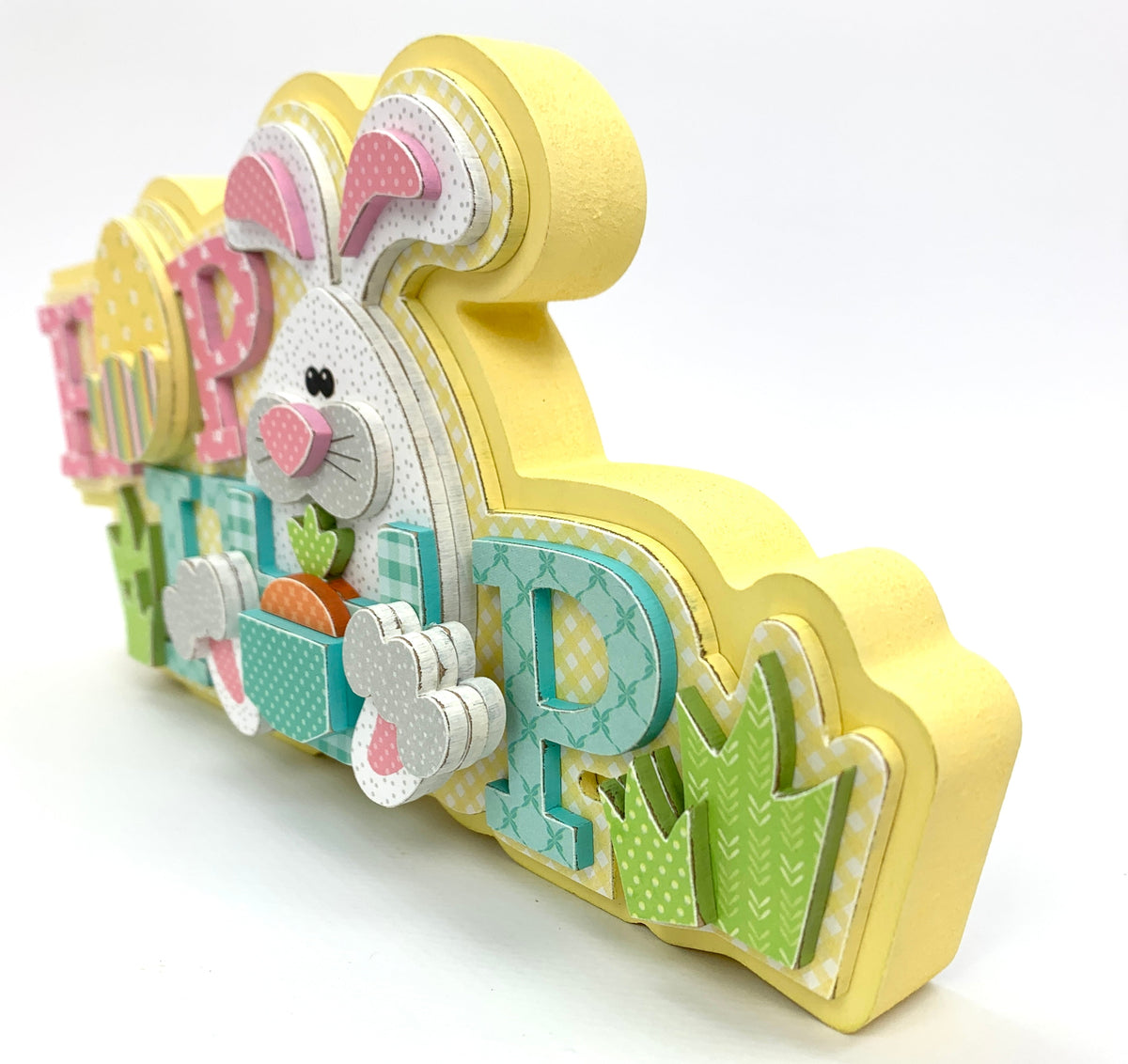 Easter bunny wood decoration with the word hop, egg, and bunny.