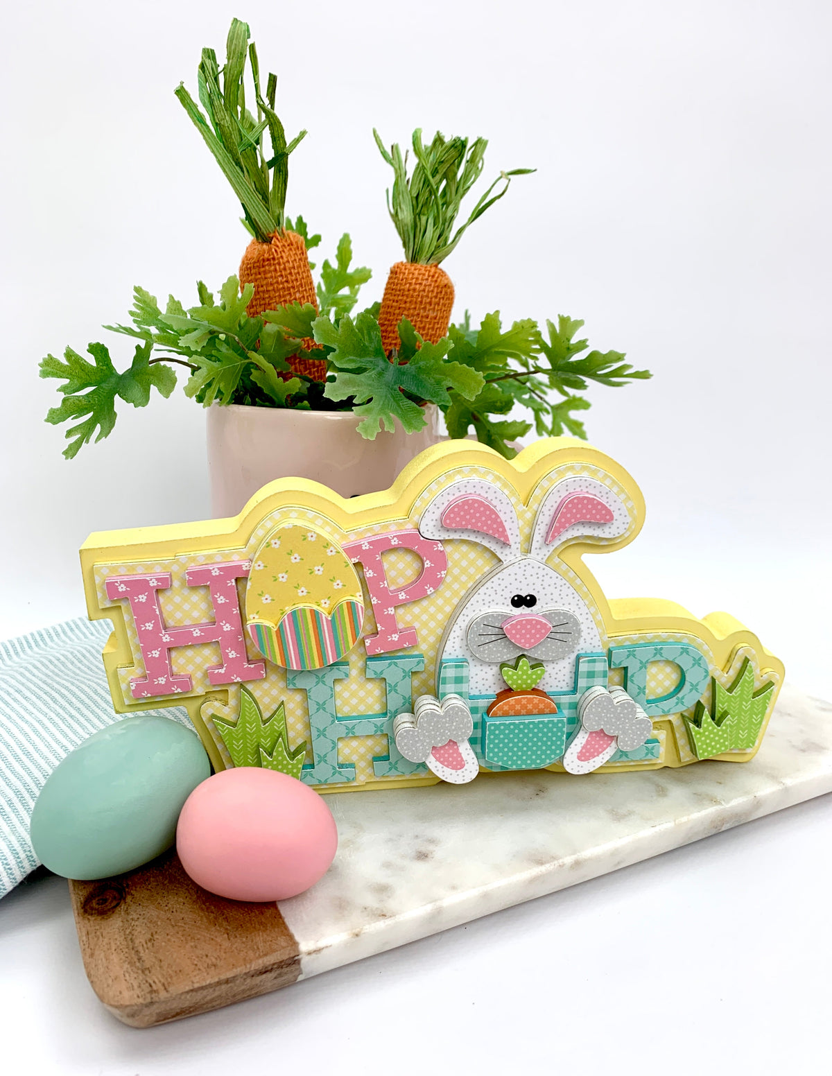 Wood easter bunny craft kit with Hop words and egg on tray with carrots.
