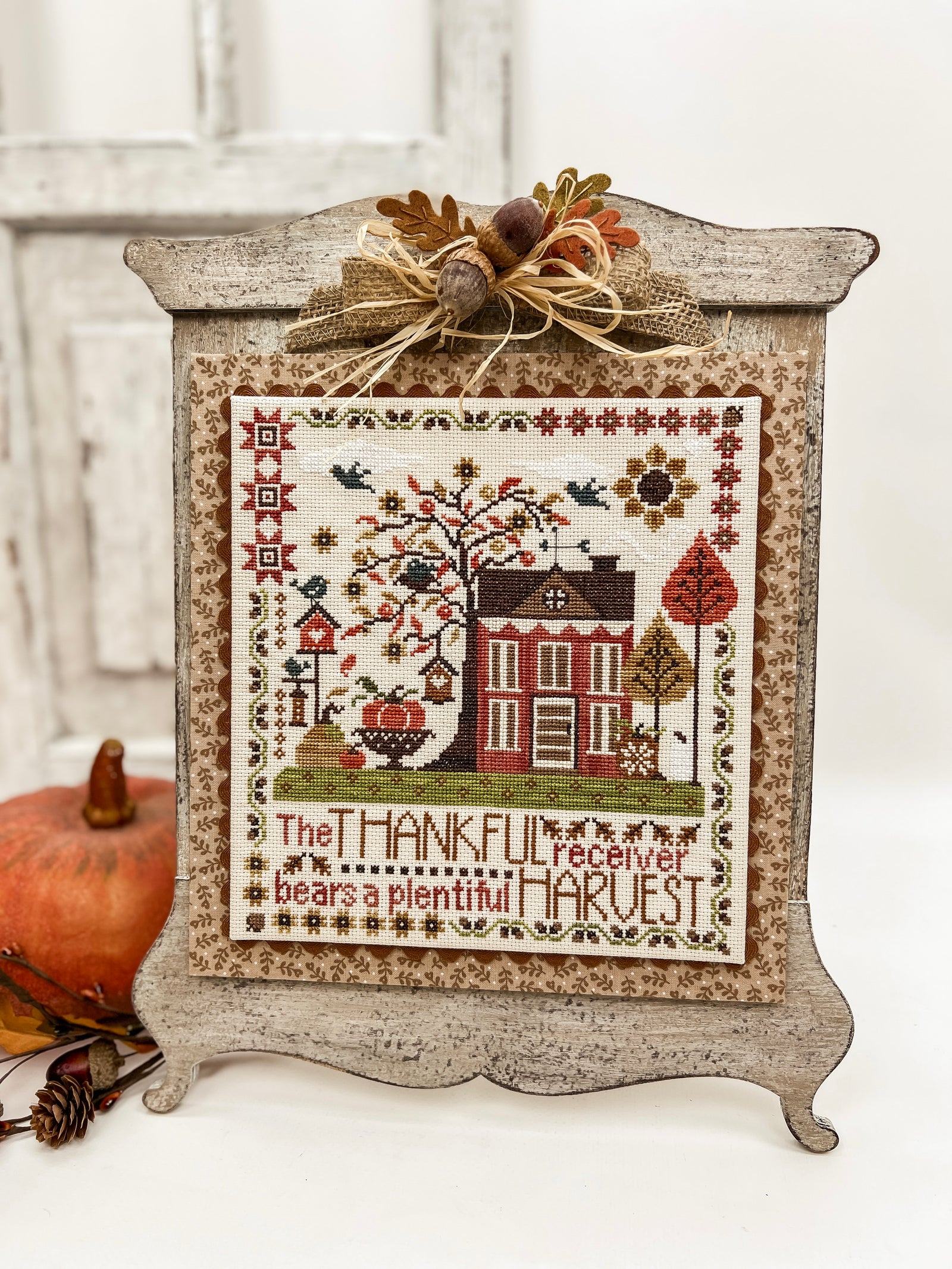 Unfinished wood Magnolia Armoire cross stitch display with a vintage furniture-inspired frame and distressed finish.