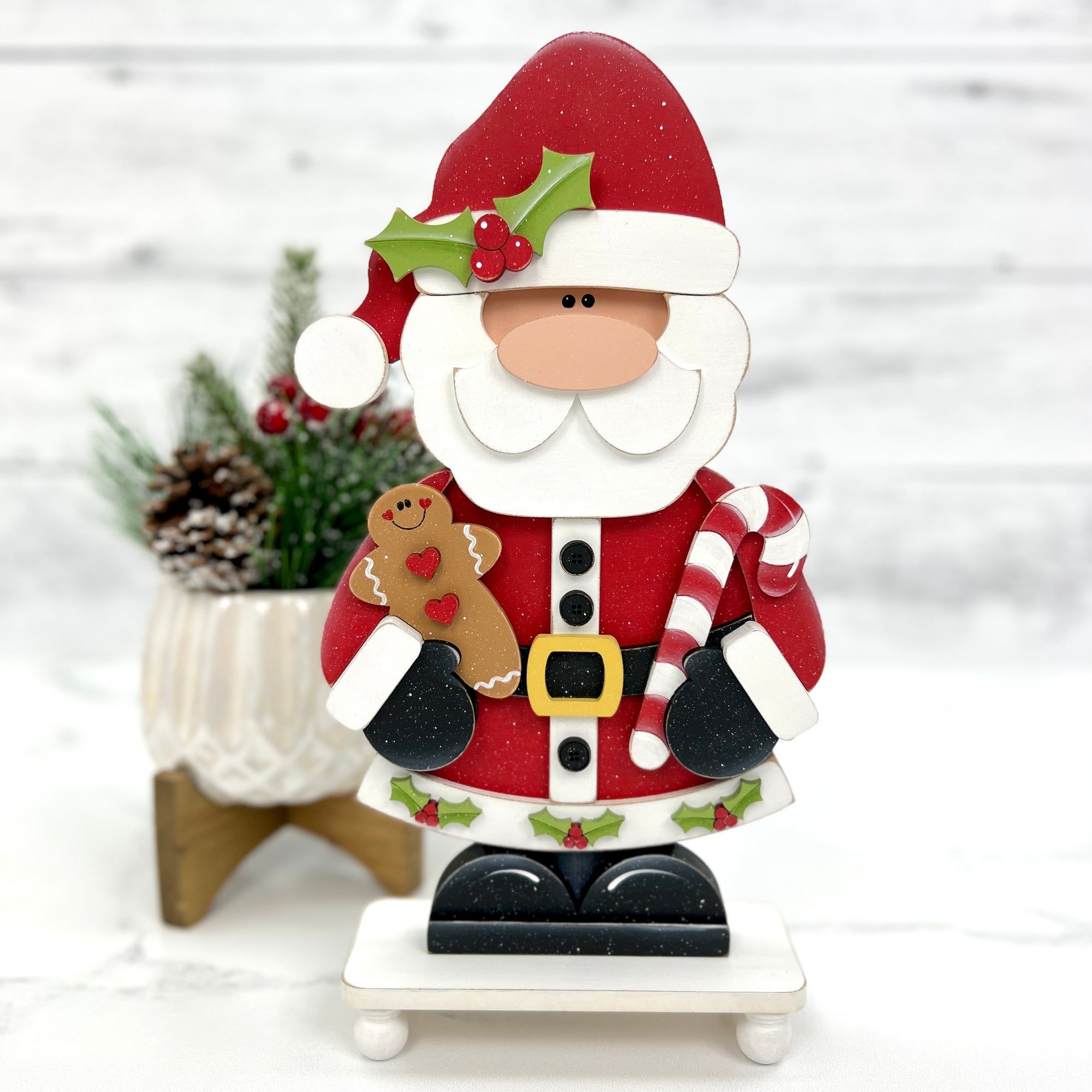 wood Santa claus holding a candy cane and gingerbread man for crafting 