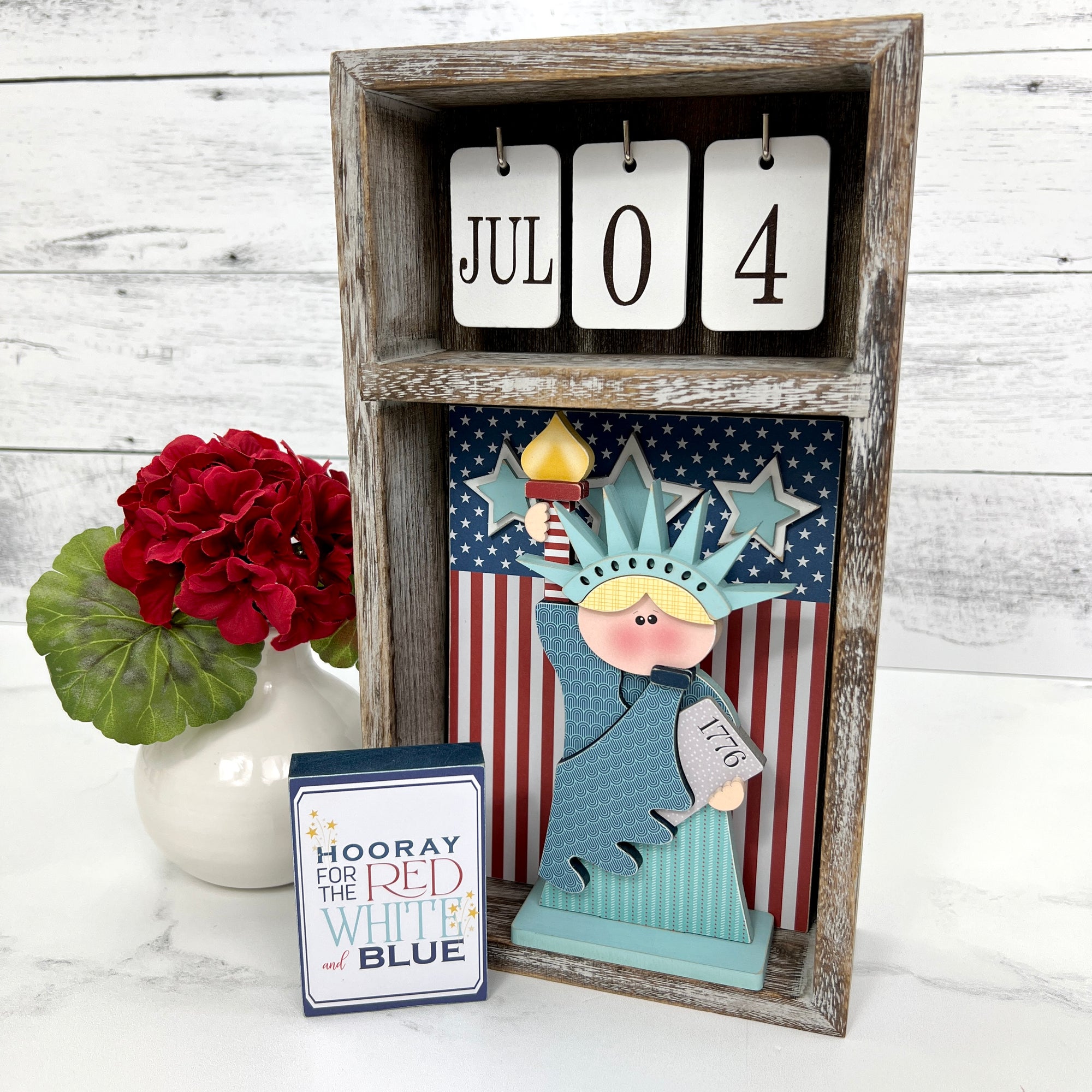 Seasonal calendar box with patriotic and 4th of july wood decorations; statue of liberty