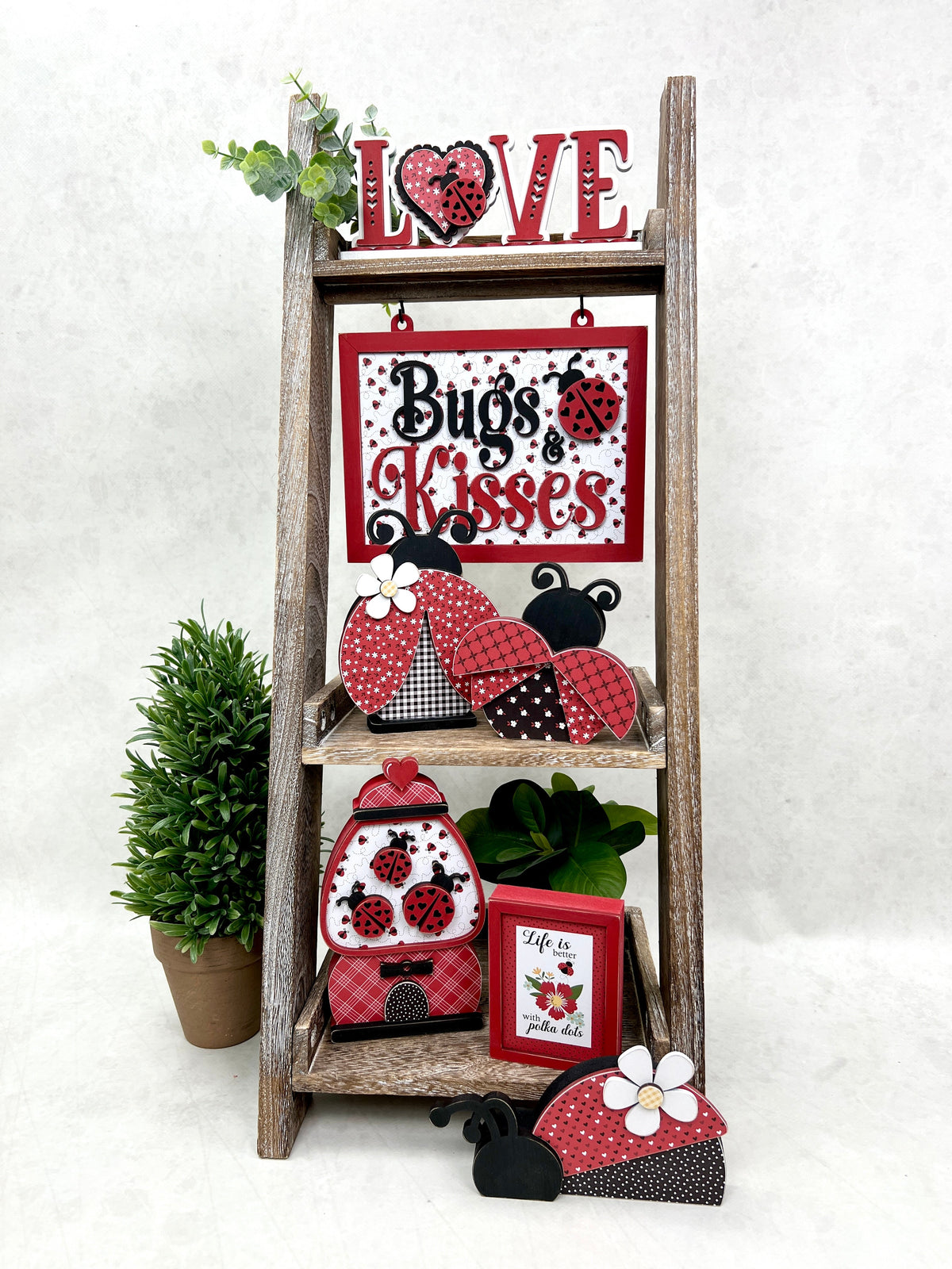 Ladybug wood decorations shown on leaning ladder shelf