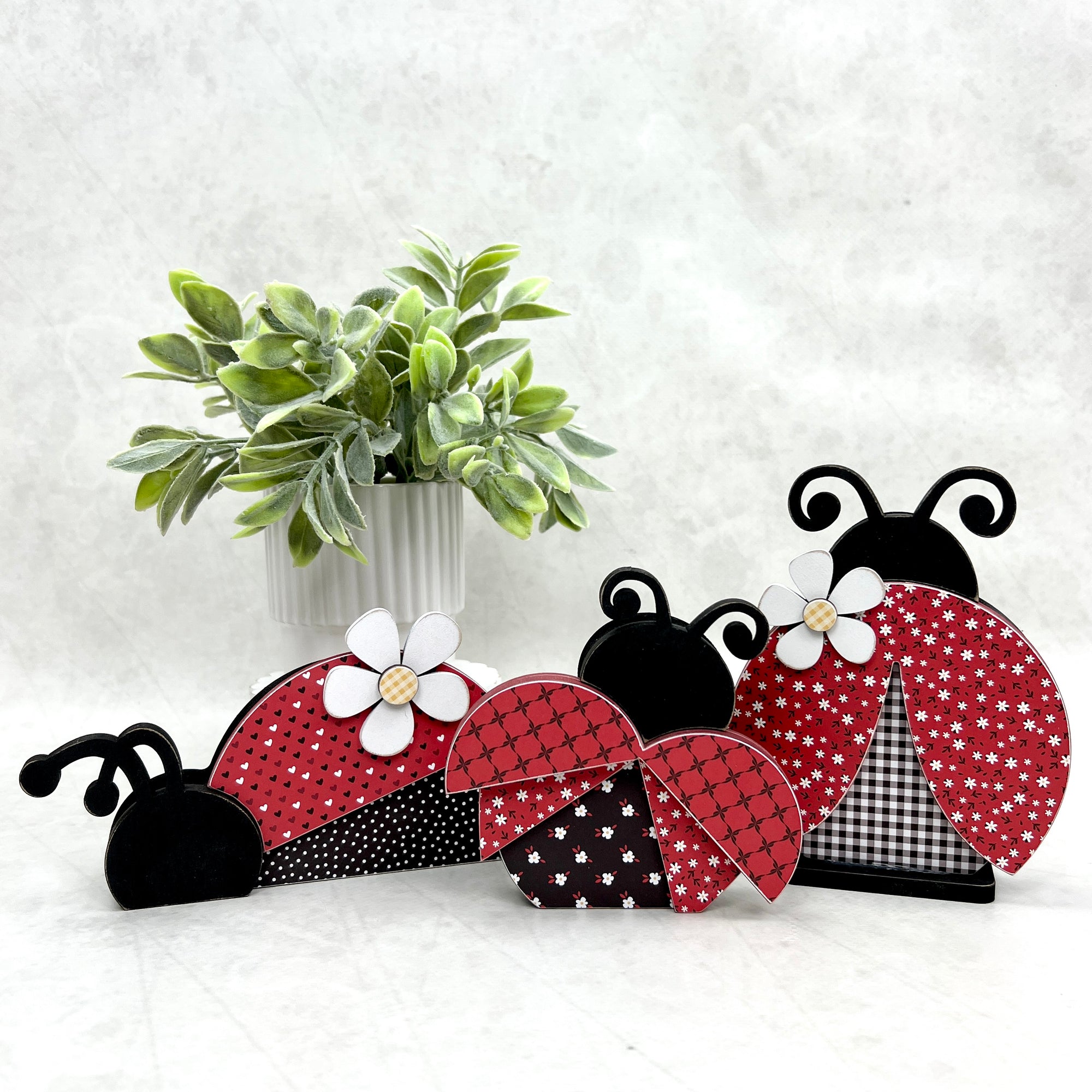 Set of 3 black and red wood ladybugs for decorating tiered trays and shelf sitters. 