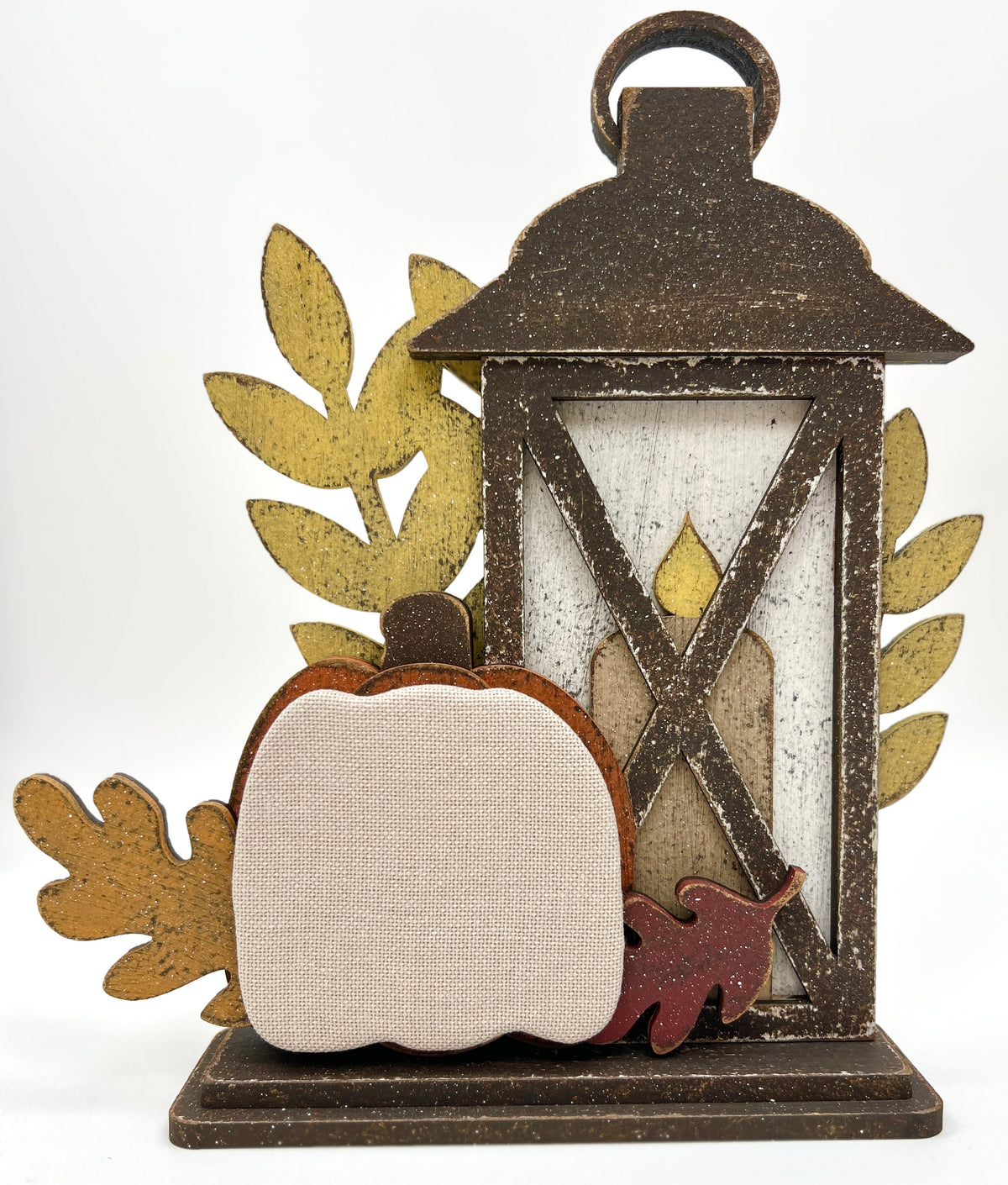 Rustic fall lantern wood display with layered pumpkin, candle, and leaf accents; painted in distressed autumn colors with space to attach a small cross stitch motif.