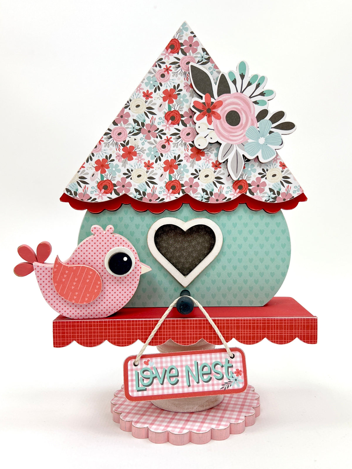 Valentine birdhouse with red, pink, and blue flowers and a small pink lovebird. Valentine wood decorations
