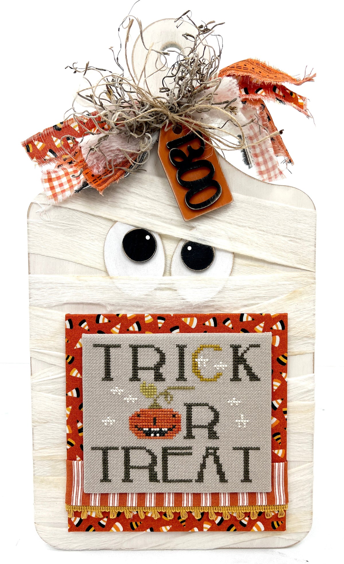 Mummy wood cross stitch display board with a finished cross stitch by Brenda Gervais.