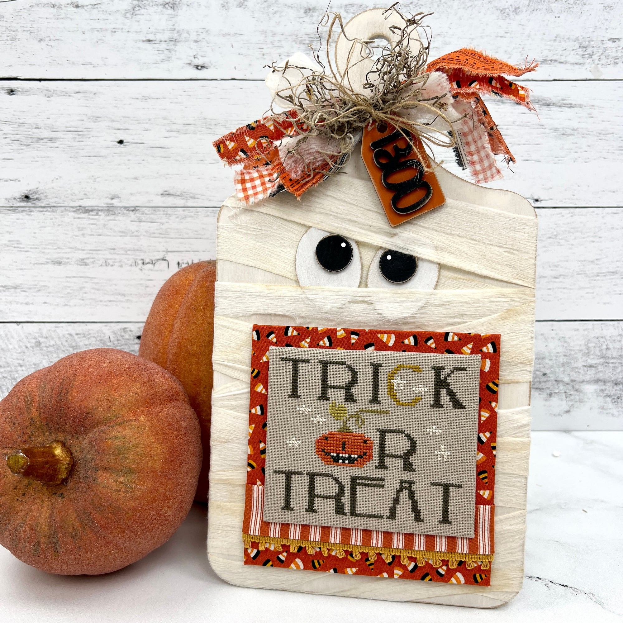 Mummy cross stitch display board with a finished Trick or Treat cross stitch design by Brenda Gervais