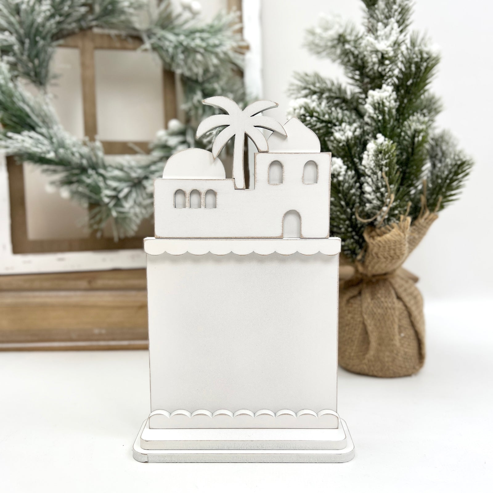 DIY Bethlehem skyline wooden frill backer for cross stitch, designed to complement the Nativity Rooftops display and showcase additional holiday stitching.