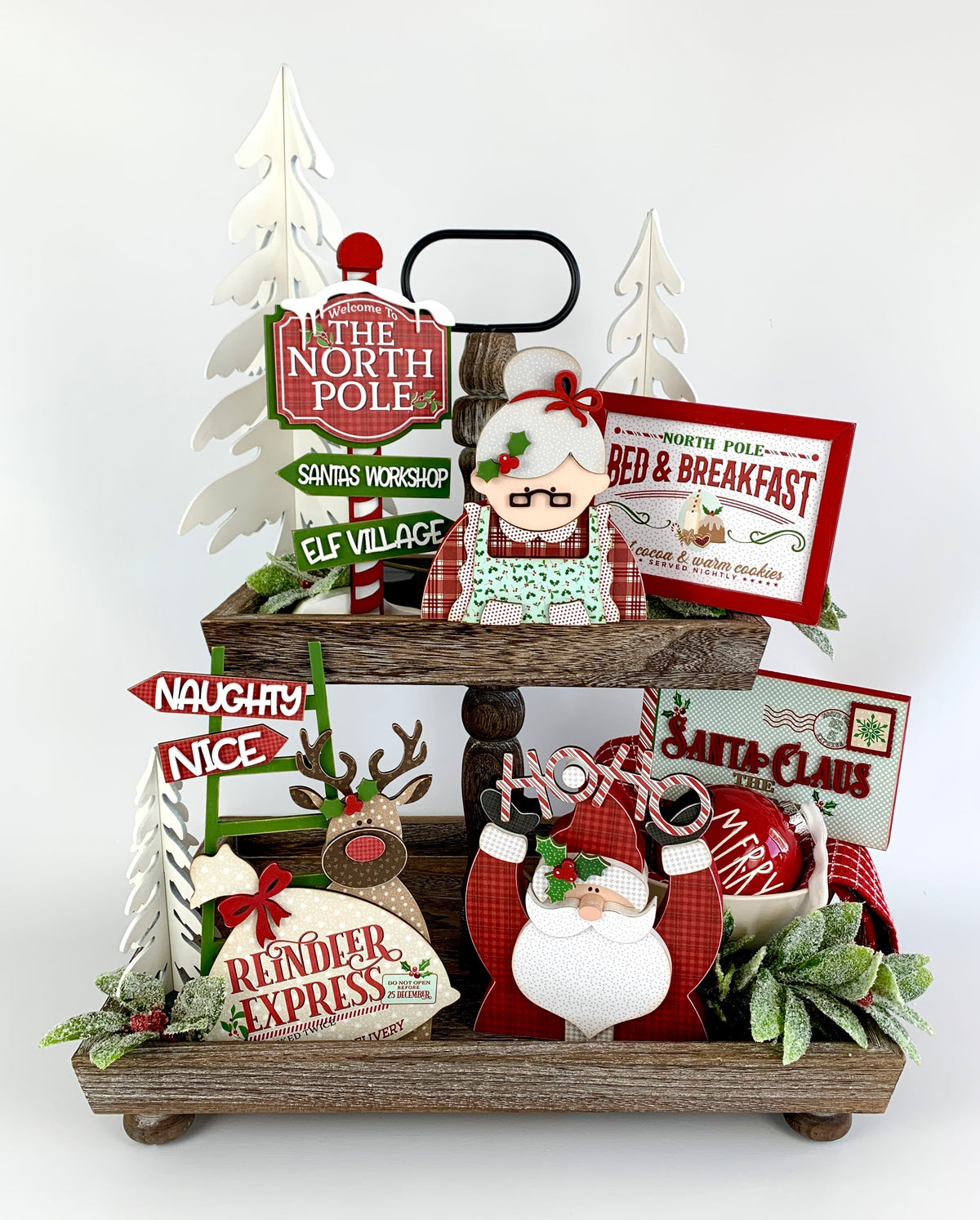 Santa North pole themed tiered tray wood decor kit.  Tiered and decorative tray wood decorations with mr and mrs claus, naughty and nice sign, letter to santa, north pole bed and breakfast, and north pole/santa workshop sign.
