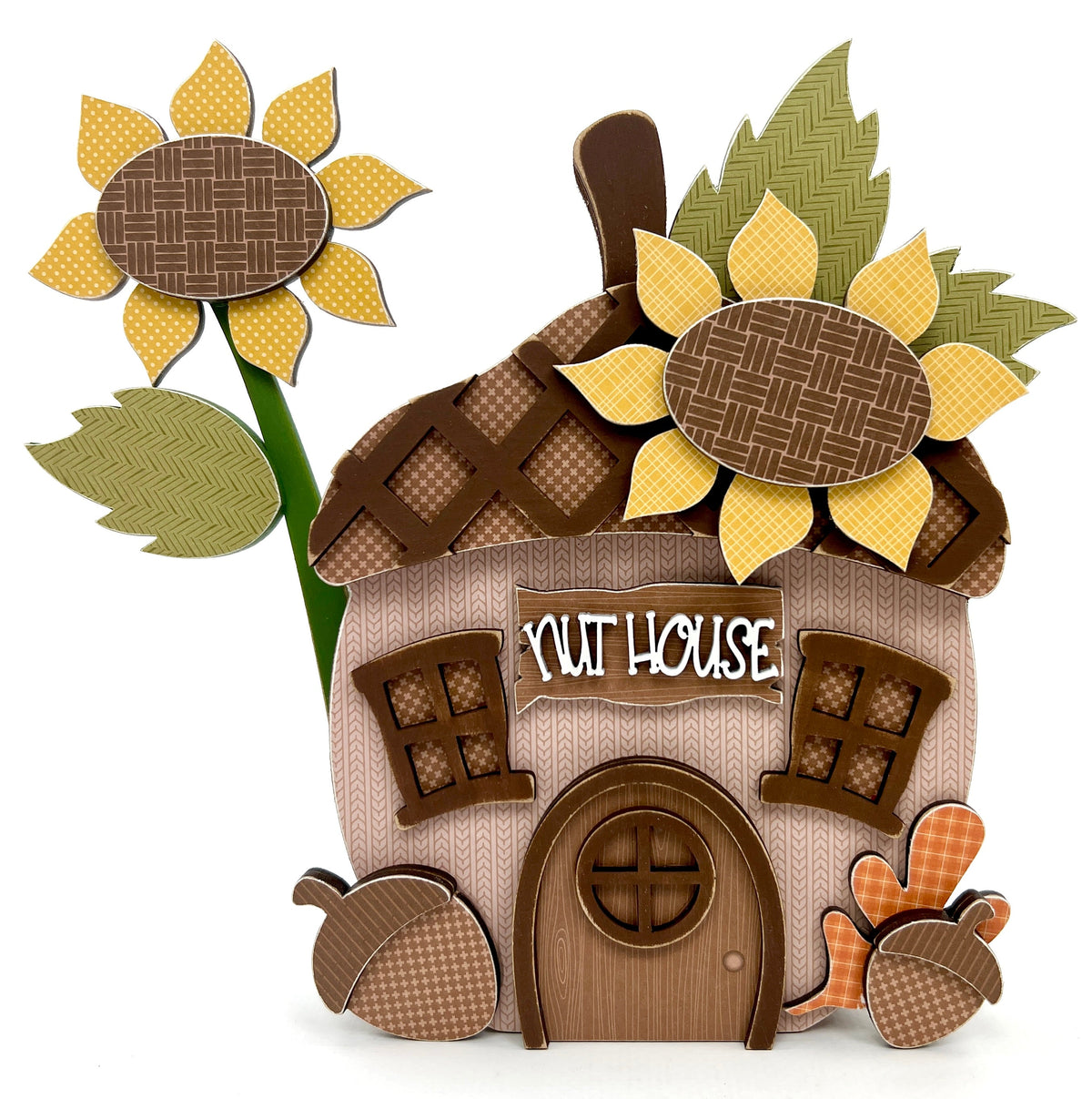 Nut house acorn with sunflowers on the top and looks like a house with windows and a door. Wood decor crafting kit.