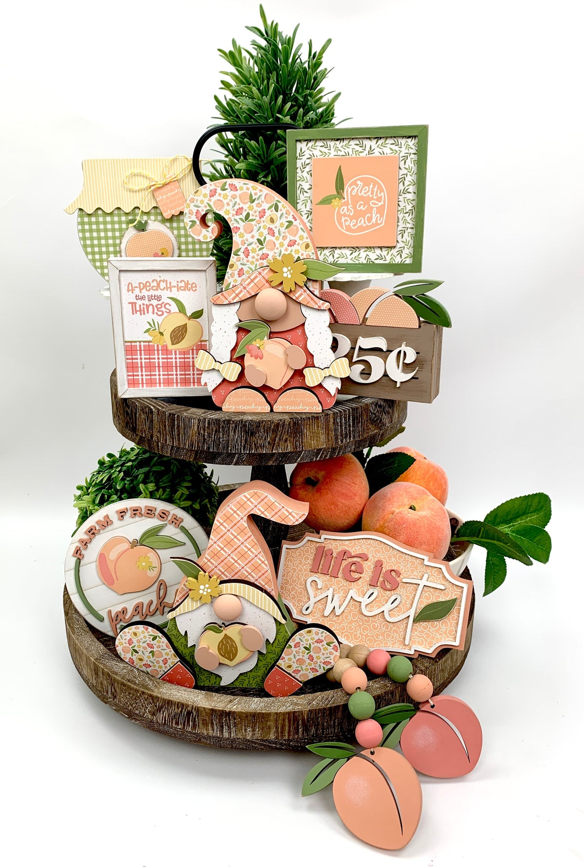 Peach themed tiered tray with wood decorations; peach gnomes, jam jar, peach signs, and wood beaded peach garland.