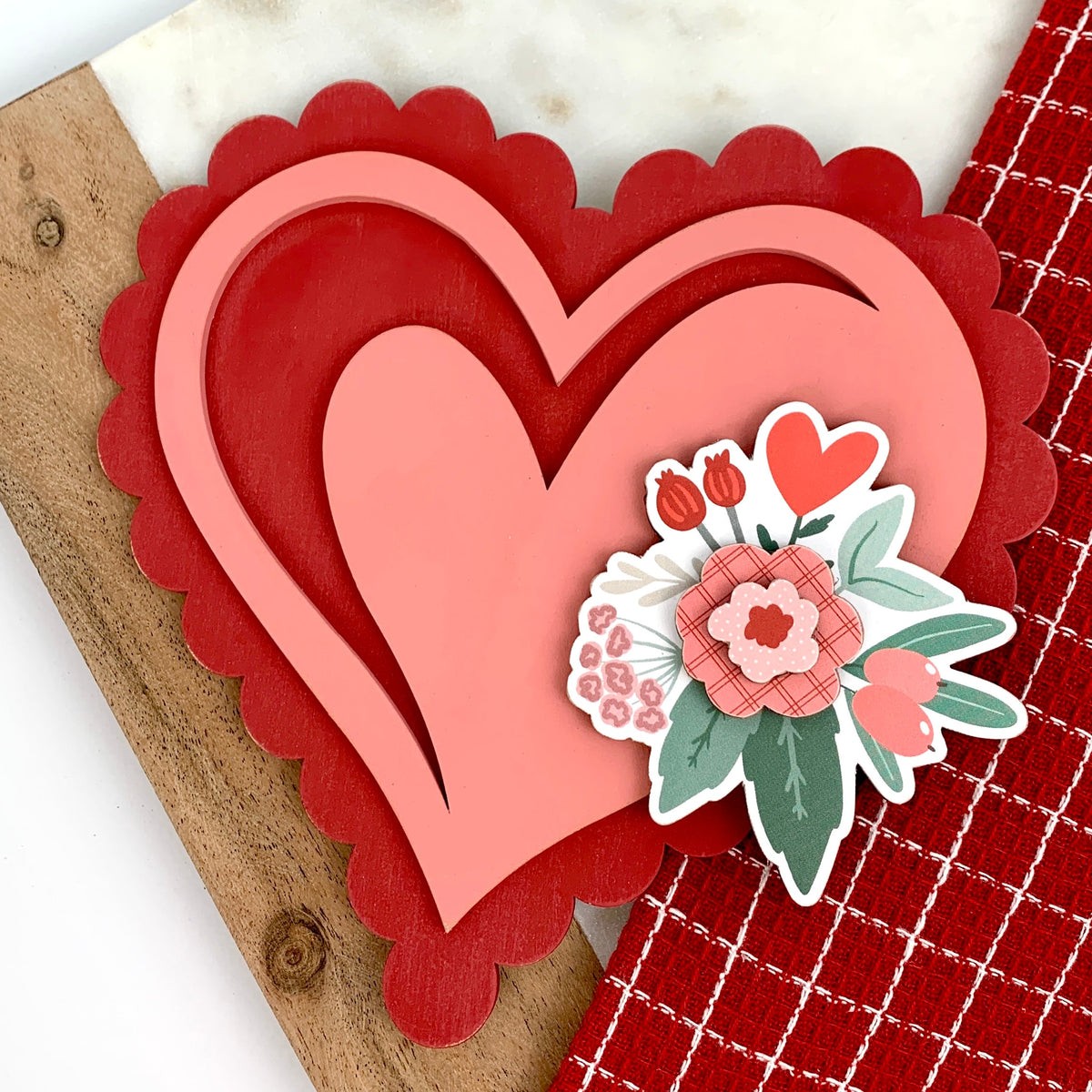 3D wood scalloped edge heart in pink and red with flowers. Valentine decoration. 
